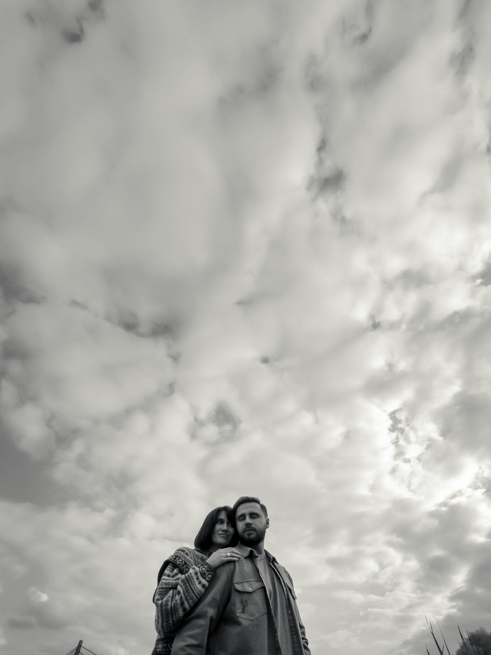 Love couple low angle dramatic sky black and white