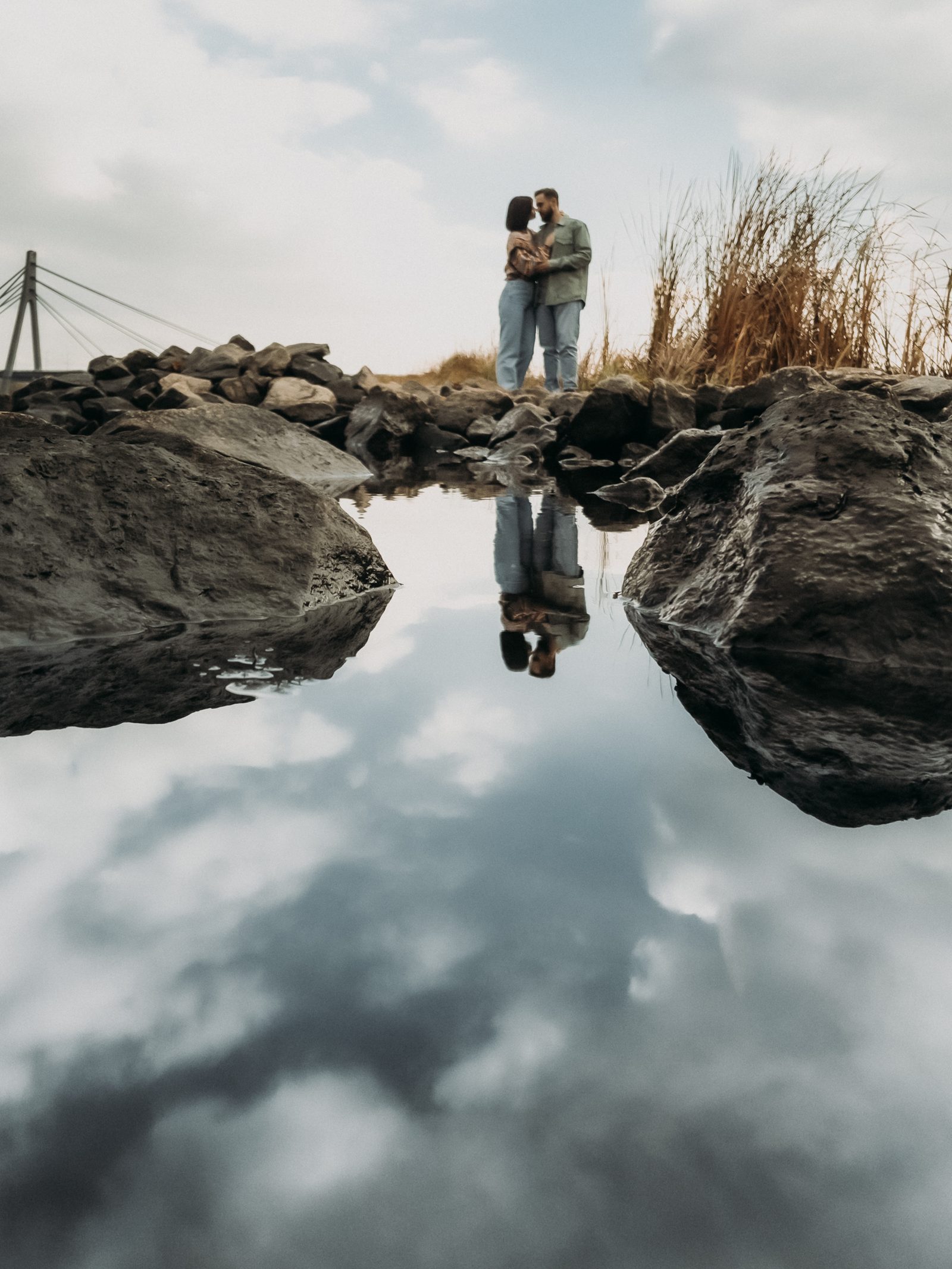 Love couple reflection rocky shoreline portrait