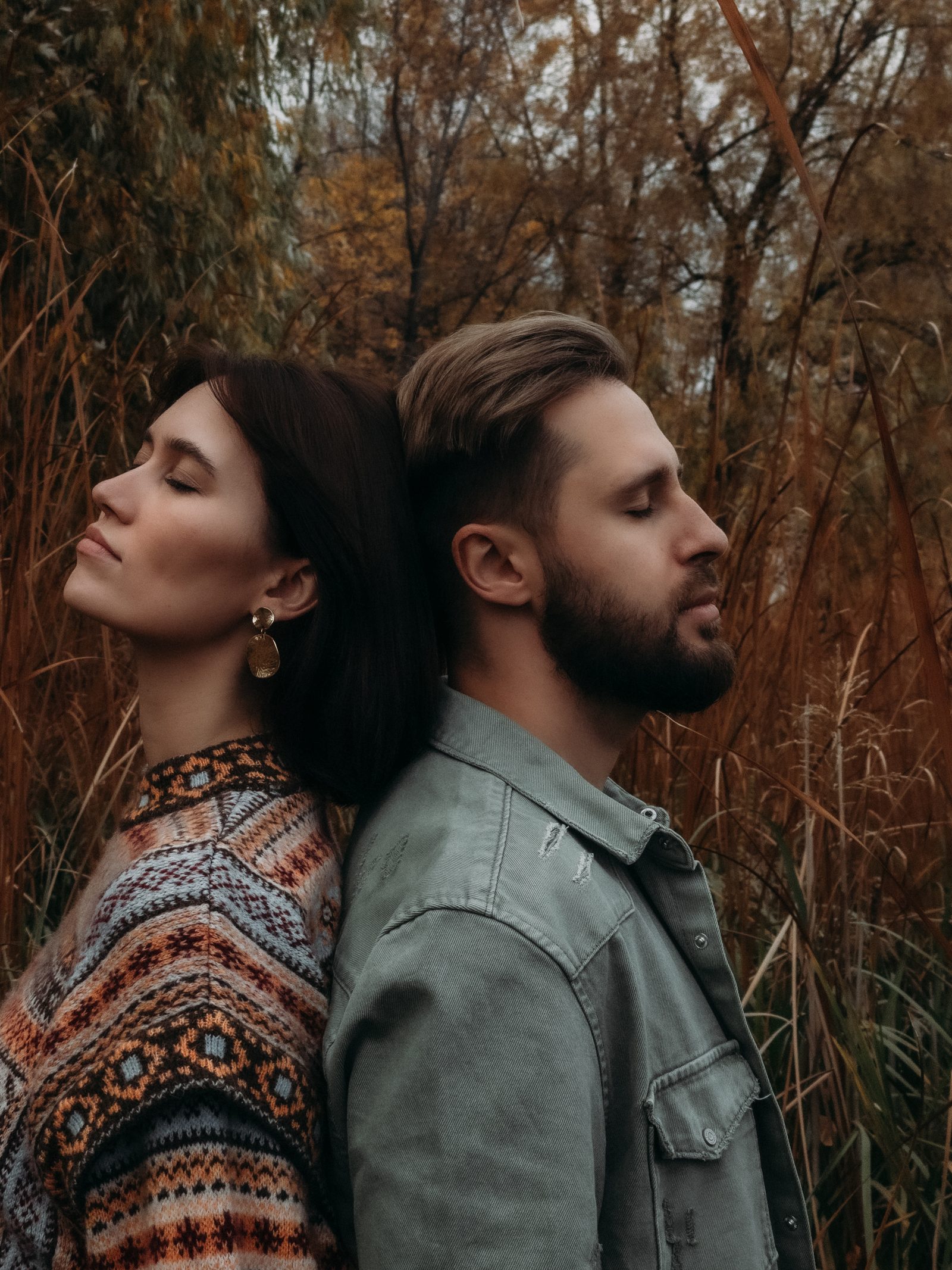 Love couple back to back portrait golden field