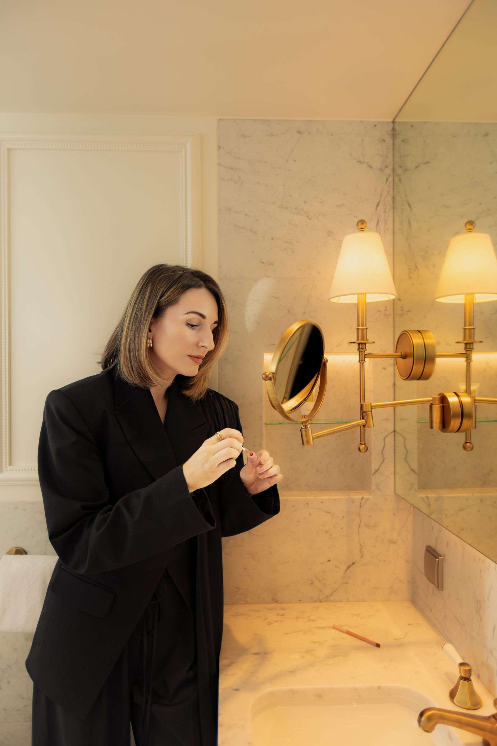 Sara black blazer nail care marble bathroom getting ready