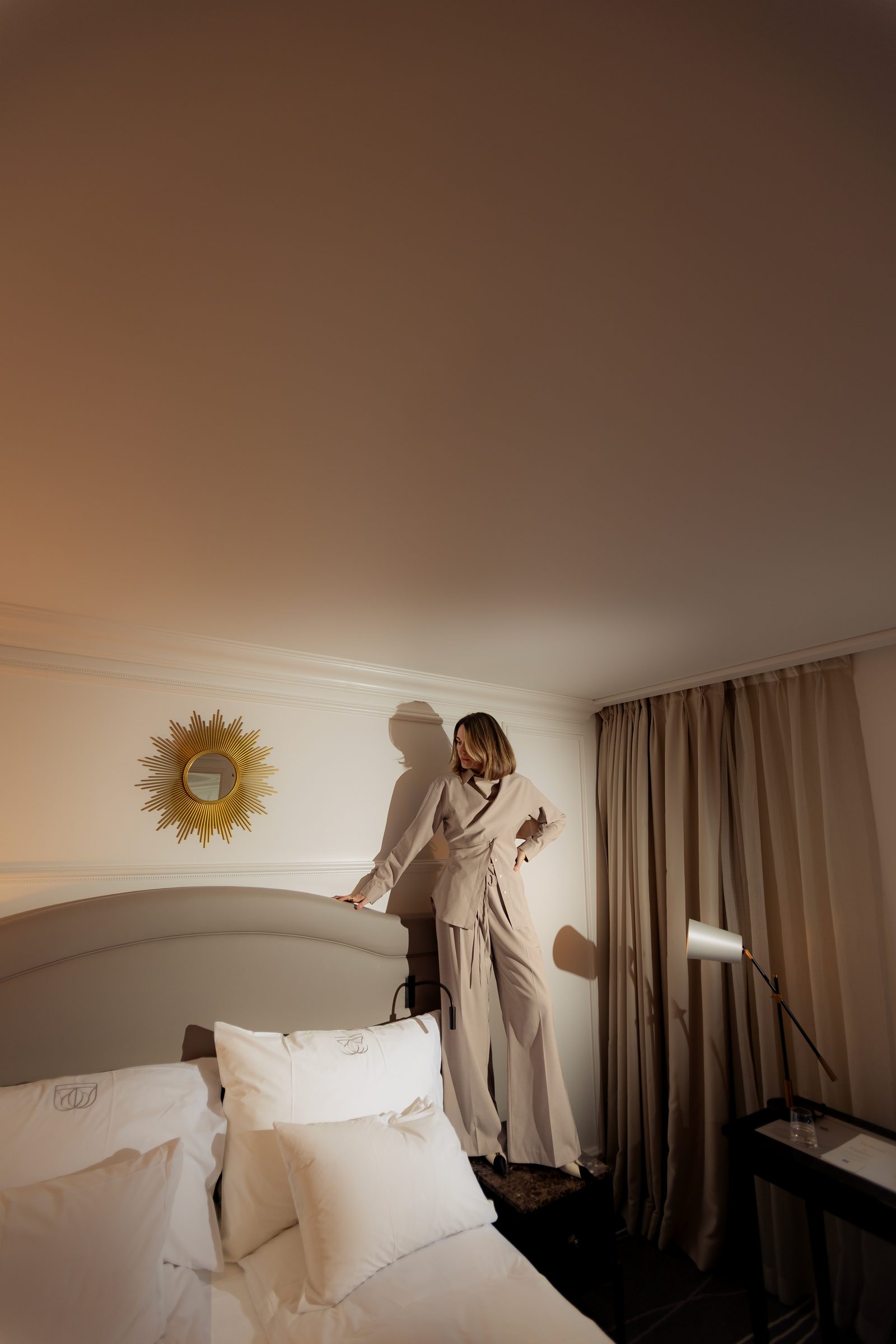 Sara beige outfit hotel bedroom golden hour editorial