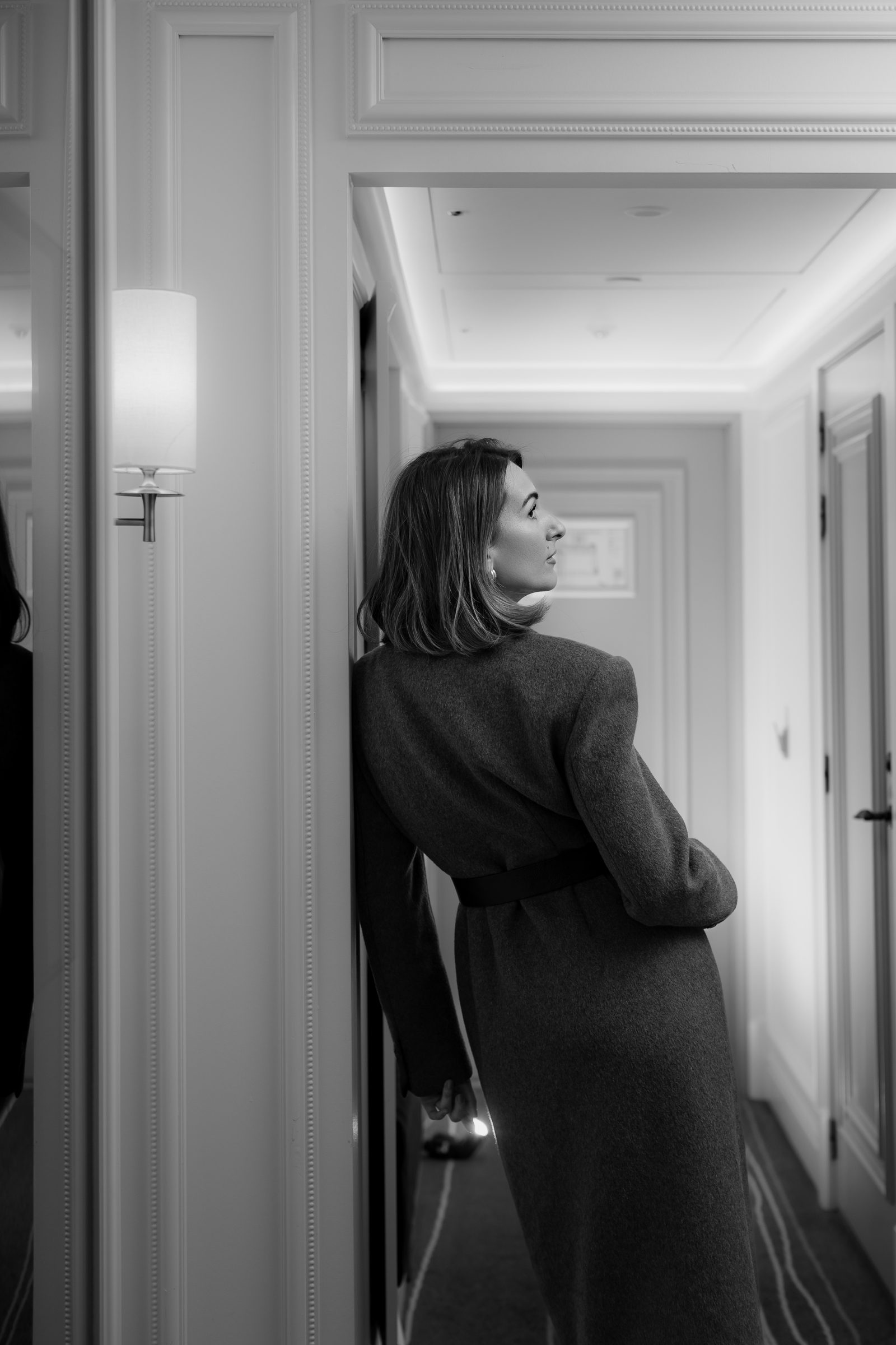 Sara black and white hallway profile grey coat