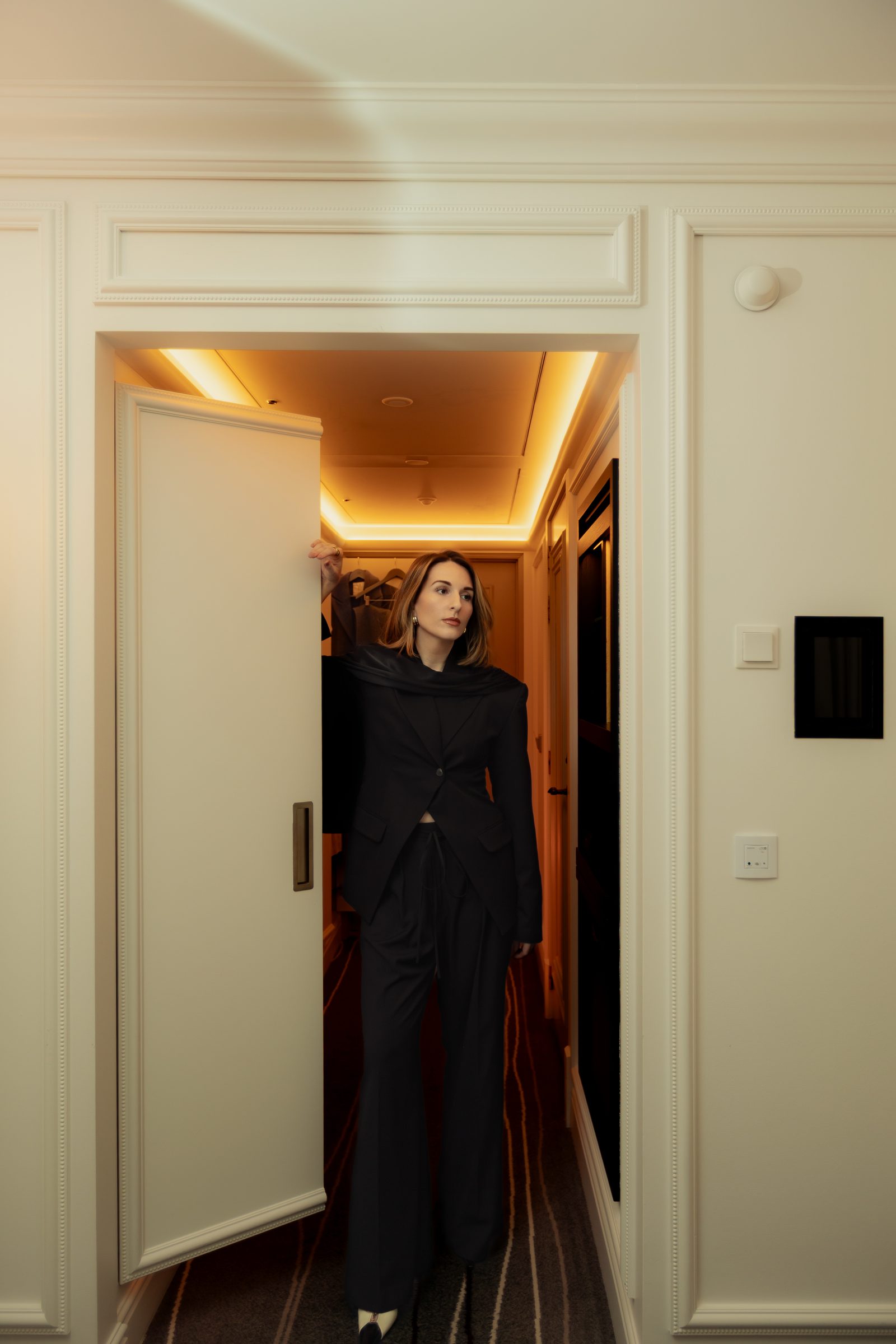Sara black suit doorway hotel hallway fashion portrait