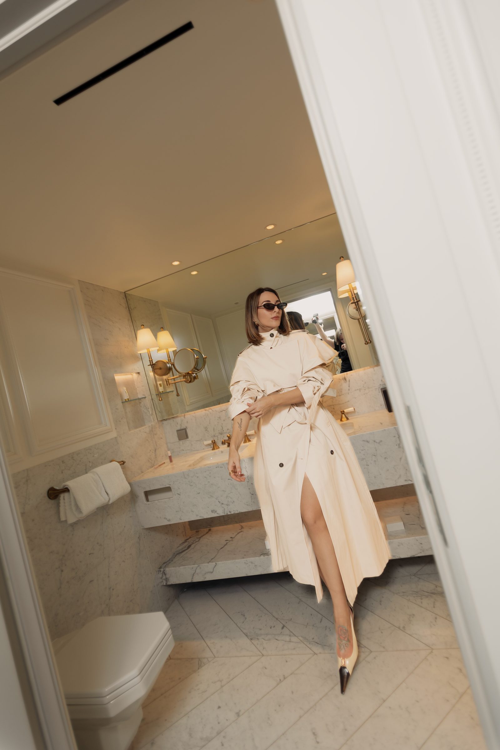 Sara cream trench bathroom mirror leg up editorial