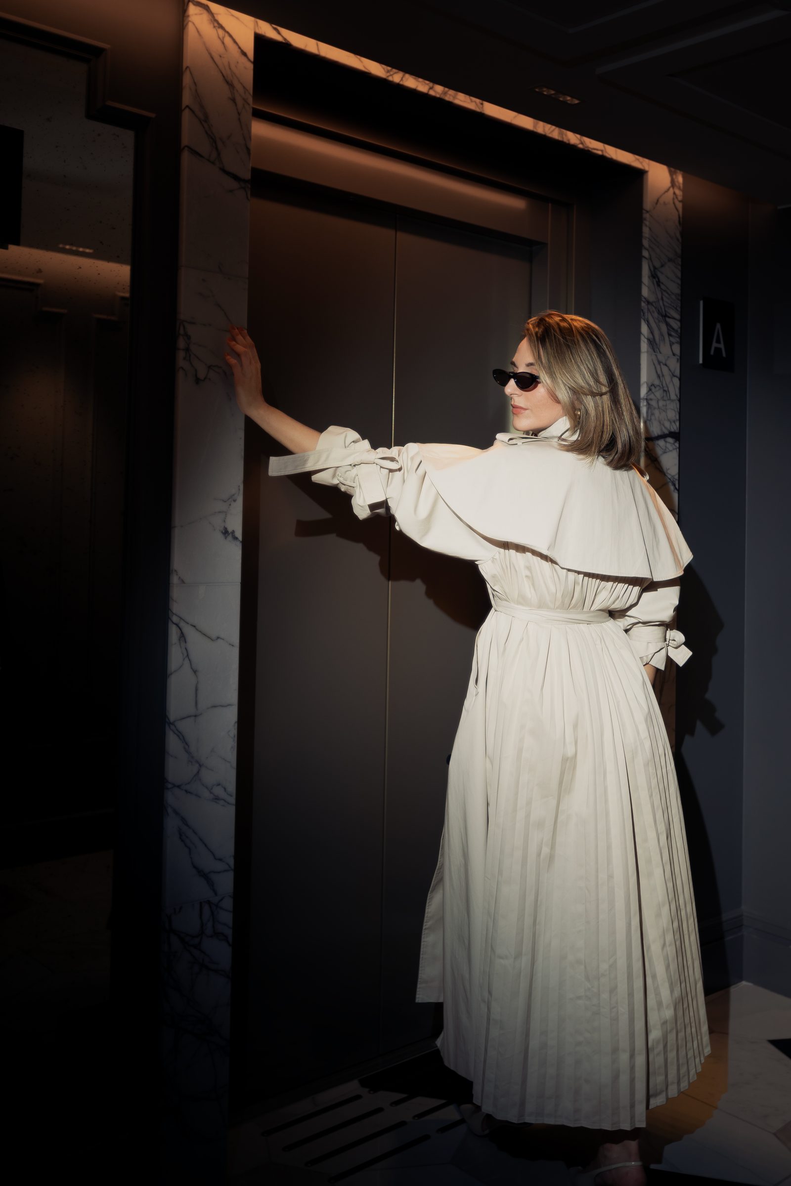 Sara cream trench elevator side profile editorial