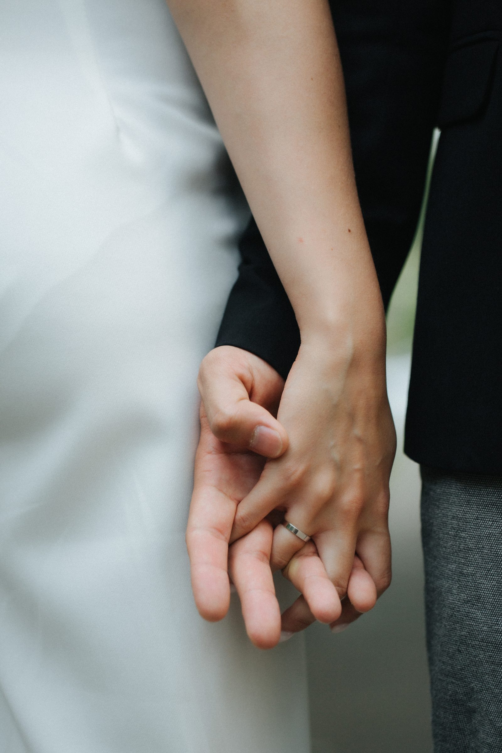 Wedding bride groom holding hands ring macro detail
