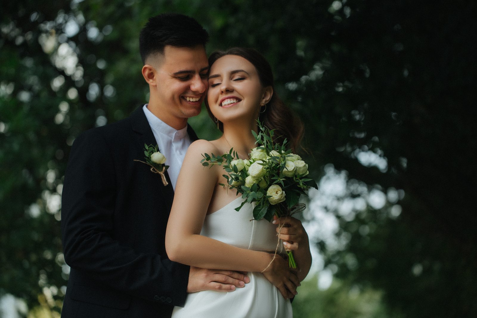 Wedding bride groom laughing candid portrait outdoors