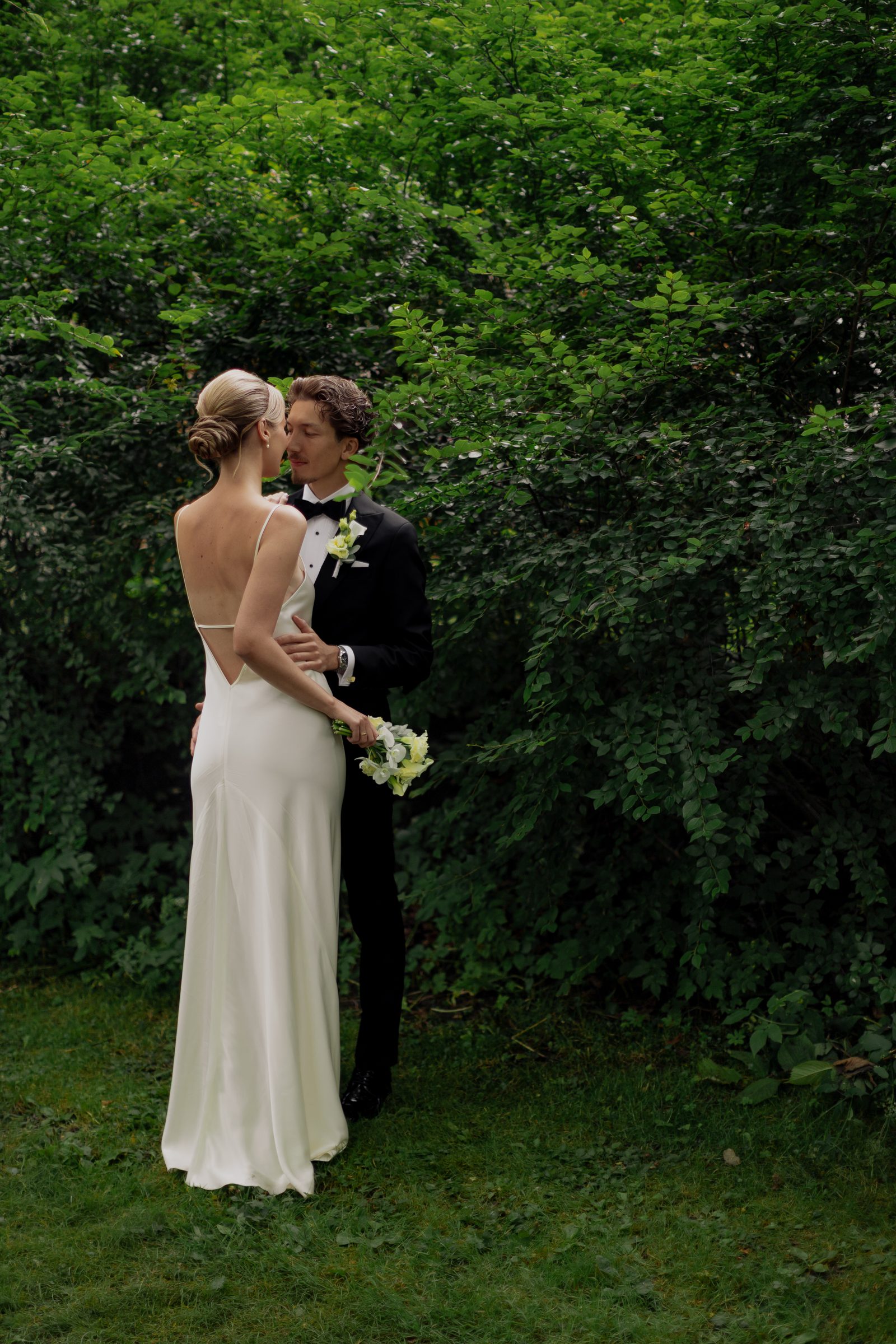 Wedding couple embrace garden portrait color