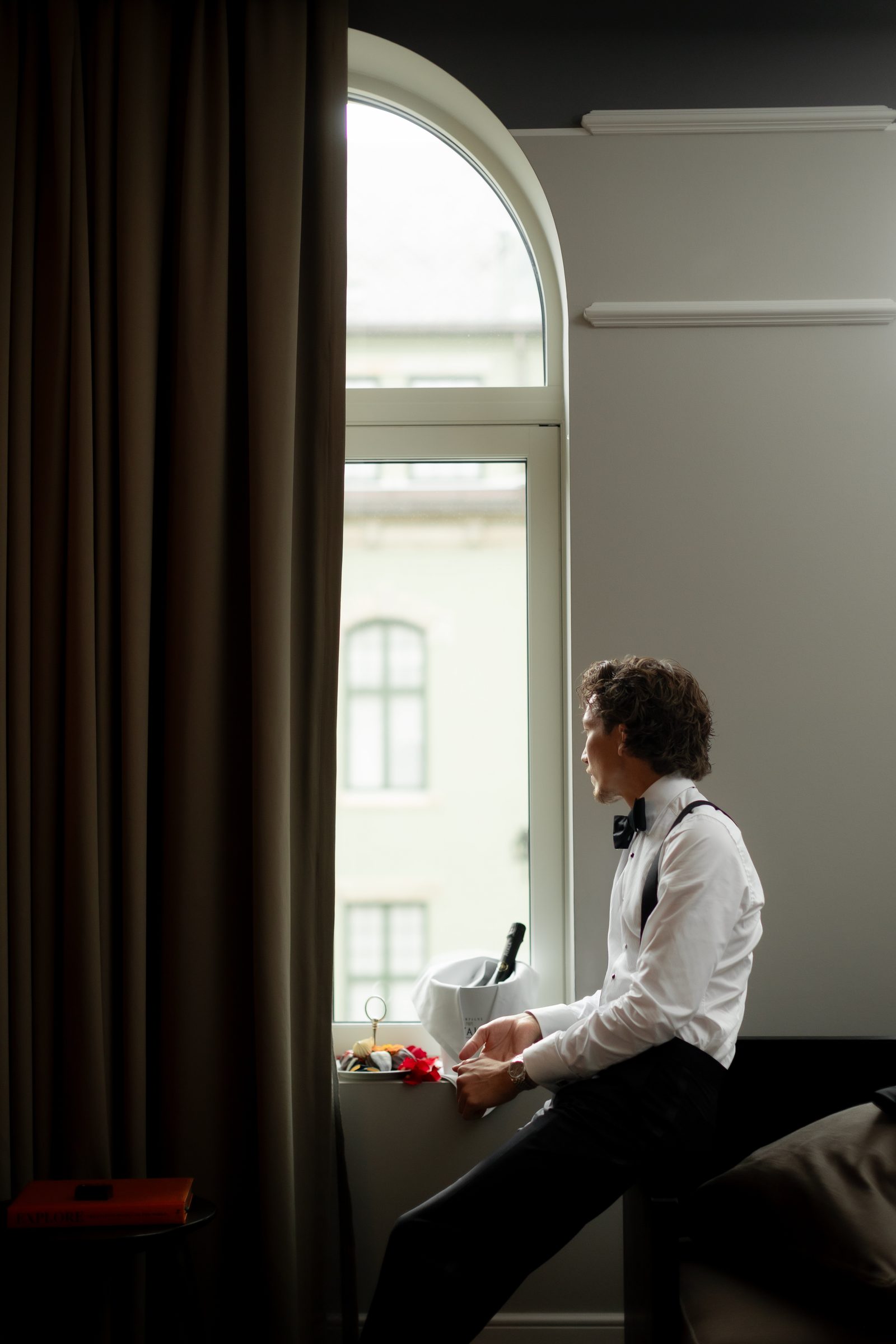 Wedding groom window portrait getting ready color