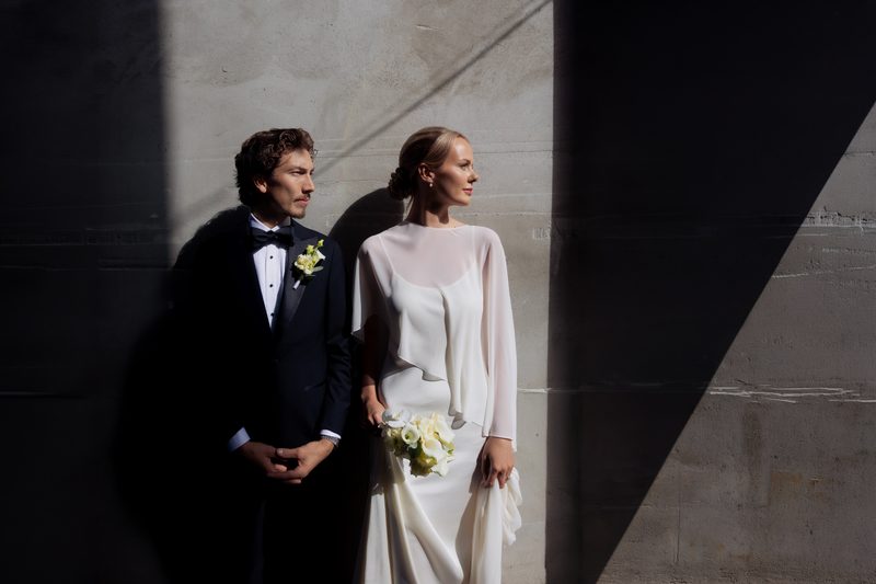 Wedding couple portrait light shadow concrete wall
